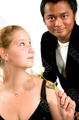 man gives rose to woman