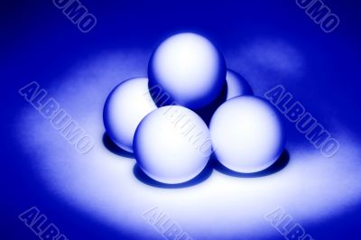 four white balls for table tennis