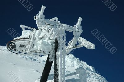 An old ski lift covered with fresh snow