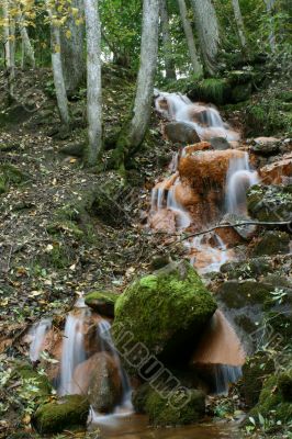 Waterfall in forest in autumn