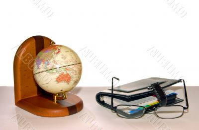 globe, notebook and glasses
