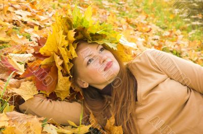 Portrait of the girl in a wreath from maple leaves