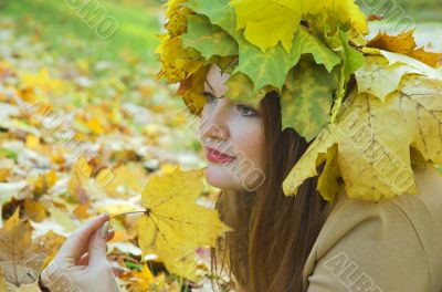 Portrait of the girl in a wreath from maple leaves