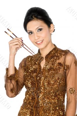 Beautiful asian girl playing with chopsticks