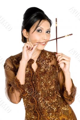 Beautiful asian girl playing with chopsticks