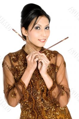Beautiful asian girl playing with chopsticks