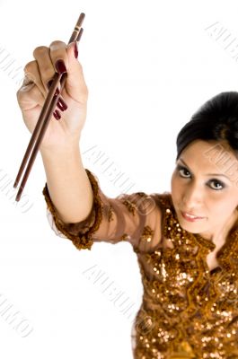 Beautiful asian girl playing with chopsticks
