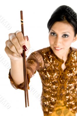 Beautiful asian girl playing with chopsticks