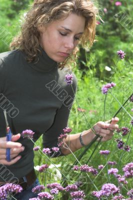 Pretty woman cutting flowers