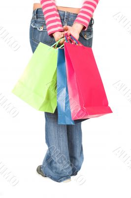 girl in jeans with shopping bags