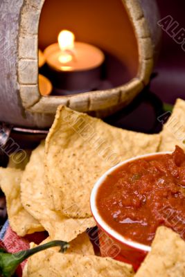 closeup of candle, chips and salsa