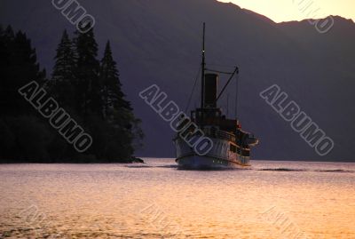 An old steamboat on mountain lake.