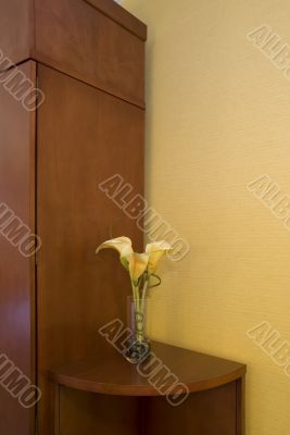 Edge of armoire and artificial flower