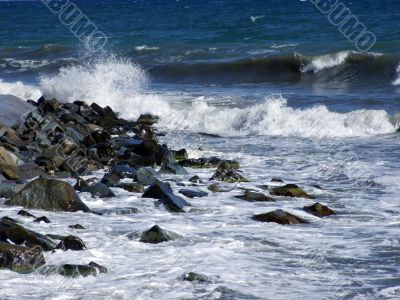 Wet stones in waves of the Black Sea