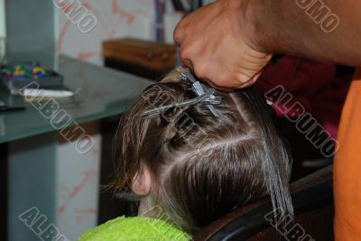 The hairdresser does a hairdress to the girl