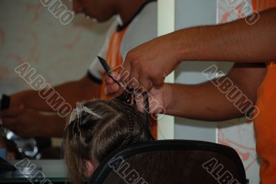 The hairdresser does a hairdress to the girl