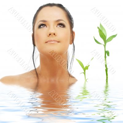 lovely brunette with bamboo in water