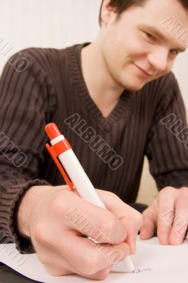 Young man writing