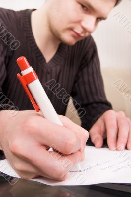 Young man writing