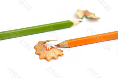 Orange and green pencils isolated on white