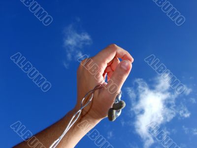 Hand with small headphones