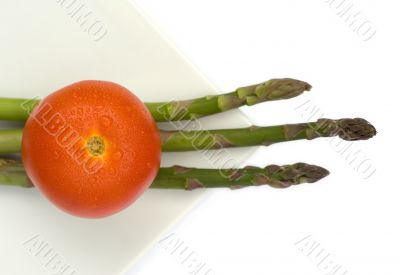 Tomato and asparagus in a white plate