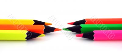 Neon pencils facing each other