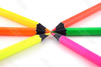 Neon pencils pointing at each other
