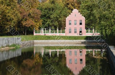 pink small house reflected in water