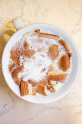 Cup with milk and biscuits