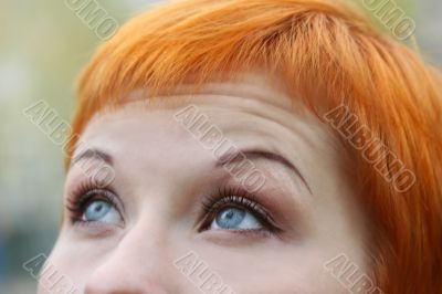 blue eyes of red-haired woman
