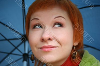 young red-haired woman with umbrella