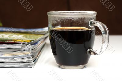 magazines and coffee mug