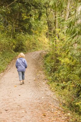 Woman Walking Through Woods