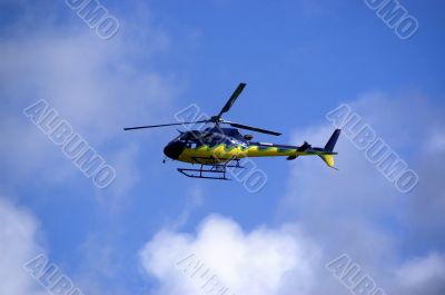 Yellow-blue Helicoper in the sky