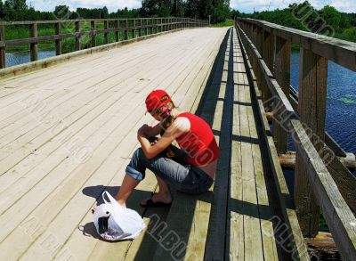 girl waiting on wooden bridge