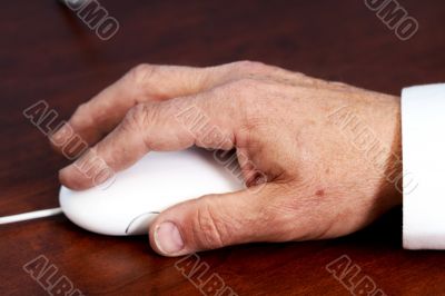 senior`s hand on mouse
