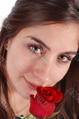Young girl smelling a rose