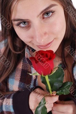 Beautiful girl smelling rose