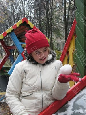 The girl with snowball in winter