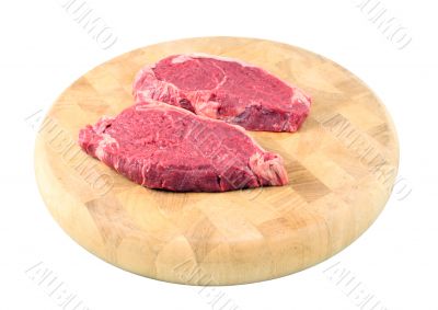 Steaks on a chopping board