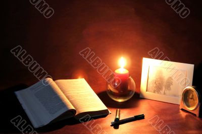 book and burning candle