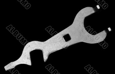 The old bicycle tool on a white background