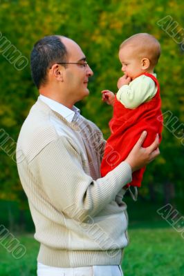 father and son in autumn park