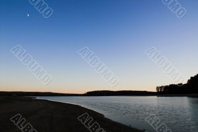 Sunset Moon over a Lake