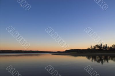 Sunset Moon over a Lake