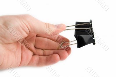 Hand with a black metal clip