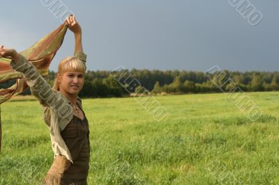 young woman with scarf in a field