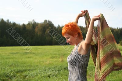 young woman with scarf in a field