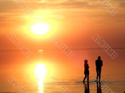 A black silhouette of a children on a sunset
